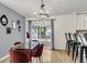 Stylish dining area with modern chandelier, glass table, and views of the screened porch at 172 Ashton Dr, Goose Creek, SC 29445