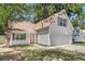Inviting home featuring a cozy porch with an American flag, two-car garage and landscaped yard at 172 Ashton Dr, Goose Creek, SC 29445