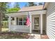 Inviting front porch with classic columns and an American flag, offering a warm welcome at 172 Ashton Dr, Goose Creek, SC 29445