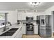 Modern kitchen with stainless steel appliances, white cabinets, and a stylish backsplash, ideal for cooking enthusiasts at 172 Ashton Dr, Goose Creek, SC 29445