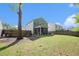 Backyard view of a two-story green home with a screened-in patio with a fenced in yard and a disc golf basket at 1723 Indaba Way, Charleston, SC 29414