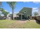 Spacious backyard with a screened patio, green lawn, storage shed, and wooden fence at 1723 Indaba Way, Charleston, SC 29414