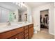 Spacious bathroom with dual sinks, tile floor, and an open doorway to a walk-in closet at 1723 Indaba Way, Charleston, SC 29414
