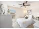 Cozy bedroom with white walls, carpet, ceiling fan, and natural light with a bed, end tables and a dresser at 1723 Indaba Way, Charleston, SC 29414