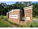 A brick entrance sign at Carolina Bay surrounded by lush greenery and decorative shrubbery at 1723 Indaba Way, Charleston, SC 29414