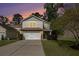 Charming two-story home featuring stone accents, a two-car garage, and a well-manicured front yard at 1723 Indaba Way, Charleston, SC 29414