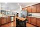 Well-lit kitchen featuring stainless steel appliances, granite countertops, and wooden cabinets at 1723 Indaba Way, Charleston, SC 29414