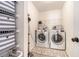 Bright laundry room with washer, dryer, shelving, storage containers and a neutral area rug at 1723 Indaba Way, Charleston, SC 29414