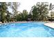 Large community swimming pool with lounge chairs and umbrellas, ideal for relaxation and recreation at 1723 Indaba Way, Charleston, SC 29414