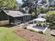 Aerial view of a home and backyard featuring a screened porch and a gazebo with seating at 1730 Harrison Ave, Charleston, SC 29407