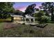 A spacious backyard with a garden, outdoor gazebo, and a charming single-Gathering home at 1730 Harrison Ave, Charleston, SC 29407