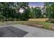 Spacious backyard featuring a concrete patio, wooden fence, and mature trees offering ample privacy at 1730 Harrison Ave, Charleston, SC 29407