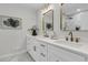 Contemporary bathroom featuring double sinks, quartz countertops, and gold framed mirrors at 1730 Harrison Ave, Charleston, SC 29407