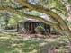 Charming home exterior featuring unique architecture, mature landscaping, and a welcoming red front door at 1730 Harrison Ave, Charleston, SC 29407