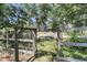 View from wooded gate leading to an inviting property exterior; rustic charm meets suburban tranquility at 1730 Harrison Ave, Charleston, SC 29407