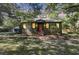 Charming home with a red front door and mature landscaping that provides excellent shade at 1730 Harrison Ave, Charleston, SC 29407