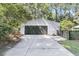 Exterior of a two car garage with a dark door and concrete driveway at 1730 Harrison Ave, Charleston, SC 29407