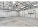 Spacious garage interior with a high ceiling, metal frame, and storage cabinets at 1730 Harrison Ave, Charleston, SC 29407