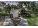 Charming guest house with white siding and a dark door is surrounded by trees and green space at 1730 Harrison Ave, Charleston, SC 29407
