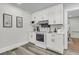Bright kitchen featuring white cabinets, modern appliances, and stylish countertops, with an open doorway into another room at 1730 Harrison Ave, Charleston, SC 29407