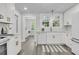 Bright, eat-in kitchen with white cabinets, quartz countertops, and stainless steel appliances at 1730 Harrison Ave, Charleston, SC 29407