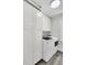 Well-lit laundry room featuring a modern washer and dryer and ample storage space with white cabinets at 1730 Harrison Ave, Charleston, SC 29407