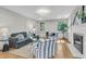 Bright living room with neutral decor, hardwood floors, ample seating, and a cozy fireplace at 1730 Harrison Ave, Charleston, SC 29407