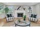 Bright living room with a fireplace, large windows, stylish furnishings, and hardwood floors at 1730 Harrison Ave, Charleston, SC 29407