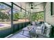 Cozy screened porch with stylish seating, ceiling fan, and view of the backyard at 1730 Harrison Ave, Charleston, SC 29407