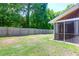 Fenced backyard with lush green grass and a screened in porch at 1816 Mepkin Rd # B1, Charleston, SC 29407
