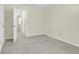 Empty bedroom showcasing neutral carpet, and view of a hallway at 1816 Mepkin Rd # B1, Charleston, SC 29407