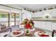 Eat-in kitchen featuring white cabinets and appliances plus a screened-in porch that offers additional entertaining space at 1816 Mepkin Rd # B1, Charleston, SC 29407