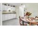 Eat-in kitchen with white cabinets and appliances, plus a wood table set for four, offering a cozy dining space at 1816 Mepkin Rd # B1, Charleston, SC 29407