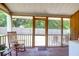 Relaxing screened porch with rocking chair, offering an outdoor retreat and peaceful views of the backyard at 1816 Mepkin Rd # B1, Charleston, SC 29407