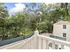 Spacious backyard showcasing mature trees and privacy fence as viewed from back deck at 19 Smith St # B, Charleston, SC 29401