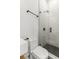 Bright bathroom with modern glass shower, white tile, and black fixtures at 19 Smith St # B, Charleston, SC 29401