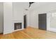 Bedroom with hardwood floors, fireplace, and open doorway to the primary bathroom at 19 Smith St # B, Charleston, SC 29401