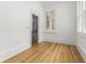 Well-lit room with hardwood floors, white walls, and a view from traditional windows at 19 Smith St # B, Charleston, SC 29401