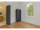 Bedroom with a closet, wood floors, and view to a tiled bathroom with walk-in shower at 19 Smith St # B, Charleston, SC 29401