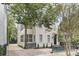 Front exterior displaying a two-story home with a brick driveway and a screened porch at 19 Smith St # B, Charleston, SC 29401