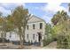 Charming two-story home featuring a well-manicured front yard, fence, and inviting entrance at 19 Smith St # B, Charleston, SC 29401