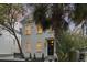 Front exterior showing a charming two-story home surrounded by lush palm trees at 19 Smith St # B, Charleston, SC 29401
