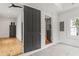 Hallway with white shiplap, connecting spaces featuring hardwood floors and tile flooring at 19 Smith St # B, Charleston, SC 29401