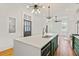 Spacious kitchen featuring a large island, white countertops, unique light fixtures, and an open floor plan at 19 Smith St # B, Charleston, SC 29401