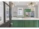 Stylish kitchen with white countertops, green cabinetry, stainless steel appliances, and unique wallpaper at 19 Smith St # B, Charleston, SC 29401