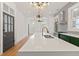 Bright, open kitchen showcasing a large island with white countertops, green cabinets, and modern appliances at 19 Smith St # B, Charleston, SC 29401