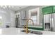 Elegant kitchen featuring white countertops, stainless steel appliances, modern finishes, and unique geometric wallpaper at 19 Smith St # B, Charleston, SC 29401
