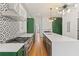 Chic kitchen featuring patterned wallpaper, stainless appliances, and modern light fixtures at 19 Smith St # B, Charleston, SC 29401