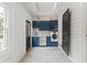 Modern laundry room showcasing updated blue cabinetry, tile floors, and new appliances at 19 Smith St # B, Charleston, SC 29401