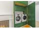 Laundry room with a stylish green cabinet with washer and dryer at 19 Smith St # B, Charleston, SC 29401